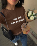 my gut has receipts baby tee, front view