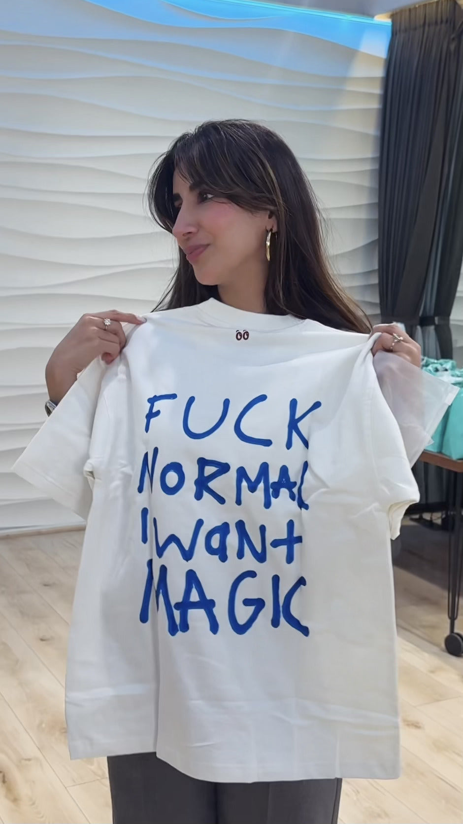 Parul Gulati holding the Fuck Normal, I Want Magic tee