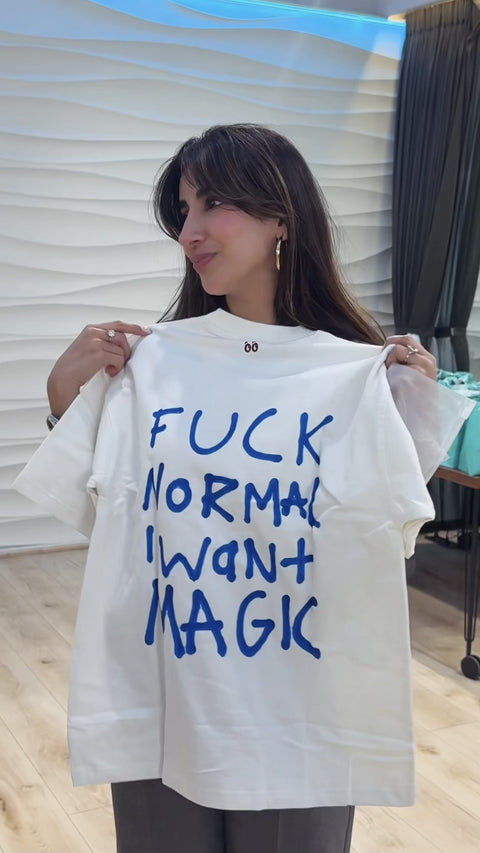 Parul Gulati holding the Fuck Normal, I Want Magic tee